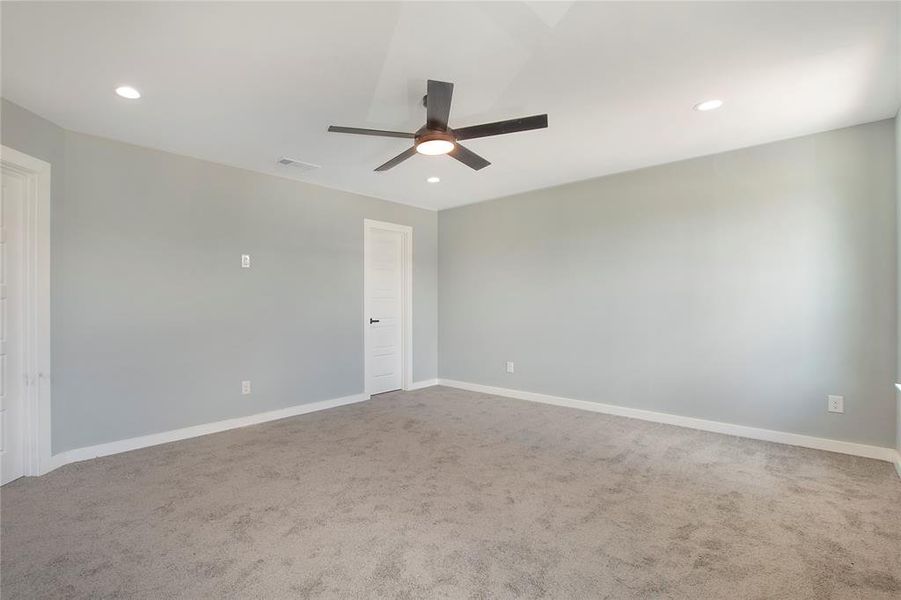 Empty room featuring ceiling fan and carpet