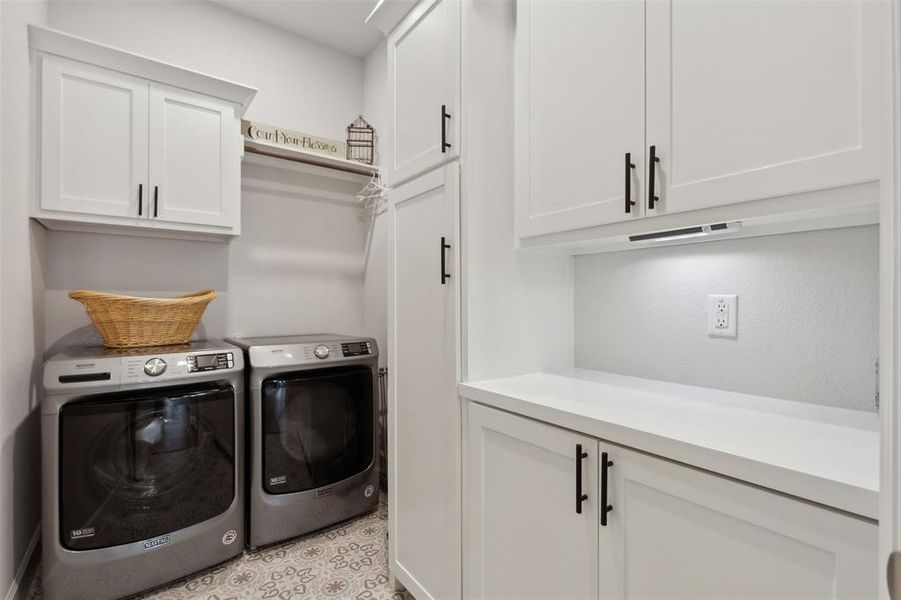Oversized laundry with added cabinets.