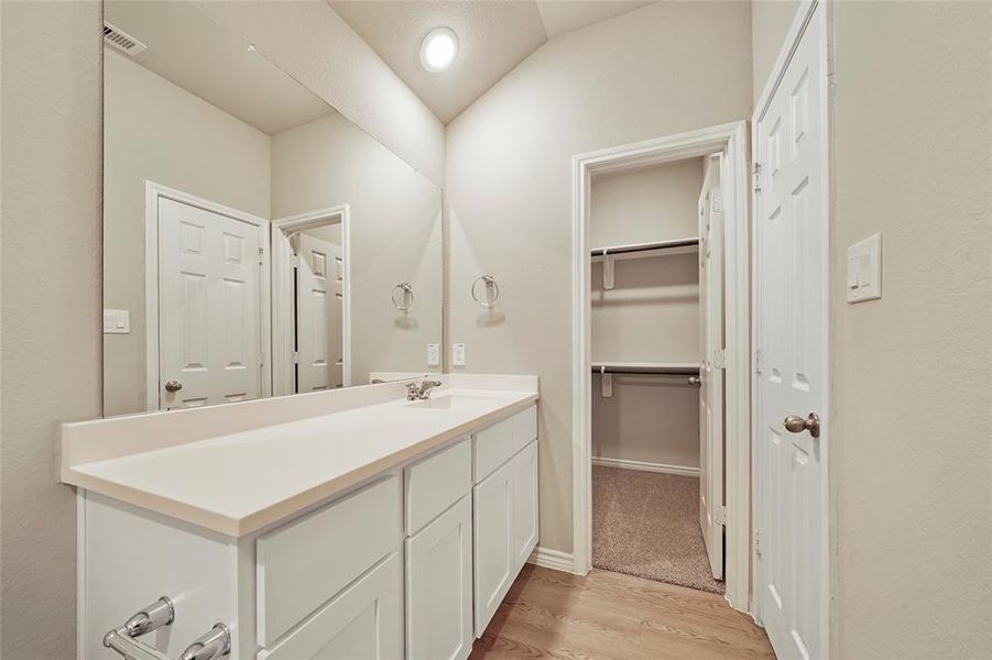 Primary bathroom with walk in closet.