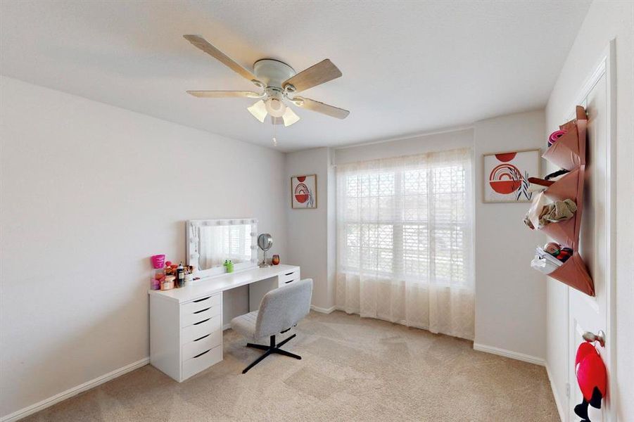 Office area featuring ceiling fan and light colored carpet