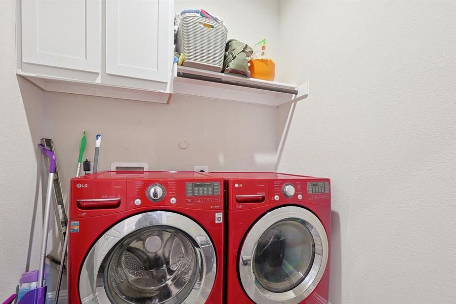 Laundry in hall with built in cabinets