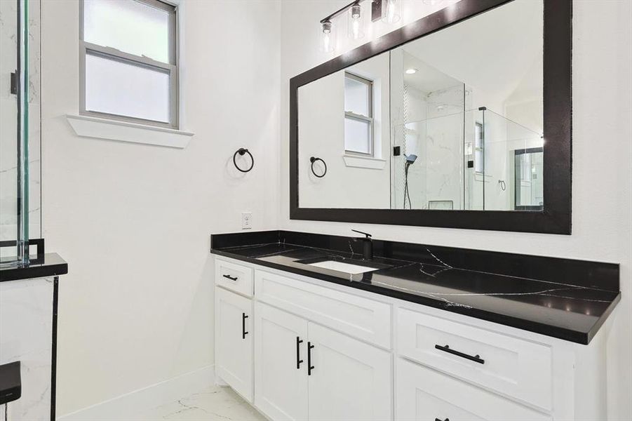 Bathroom featuring vanity and an enclosed shower