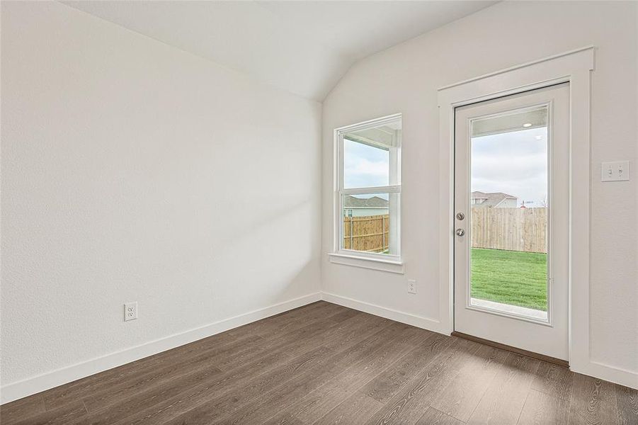 Entryway with vaulted ceiling and dark hardwood / wood-style flooring