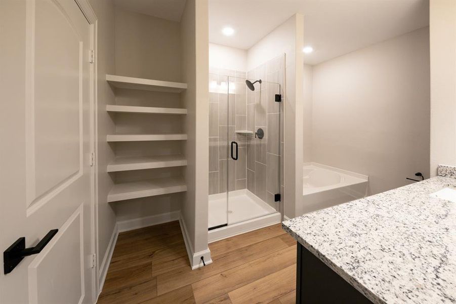 Experience serenity in the en-suite bathroom, where a stylish vanity provides a focal point for the room, and a separate tub and shower combo offer the epitome of comfort and convenience.