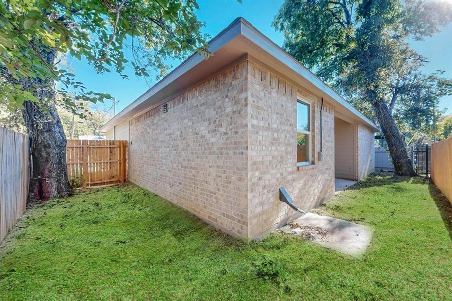 View of property exterior featuring a lawn