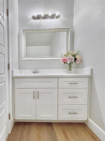 Bathroom with vanity and hardwood / wood-style floors