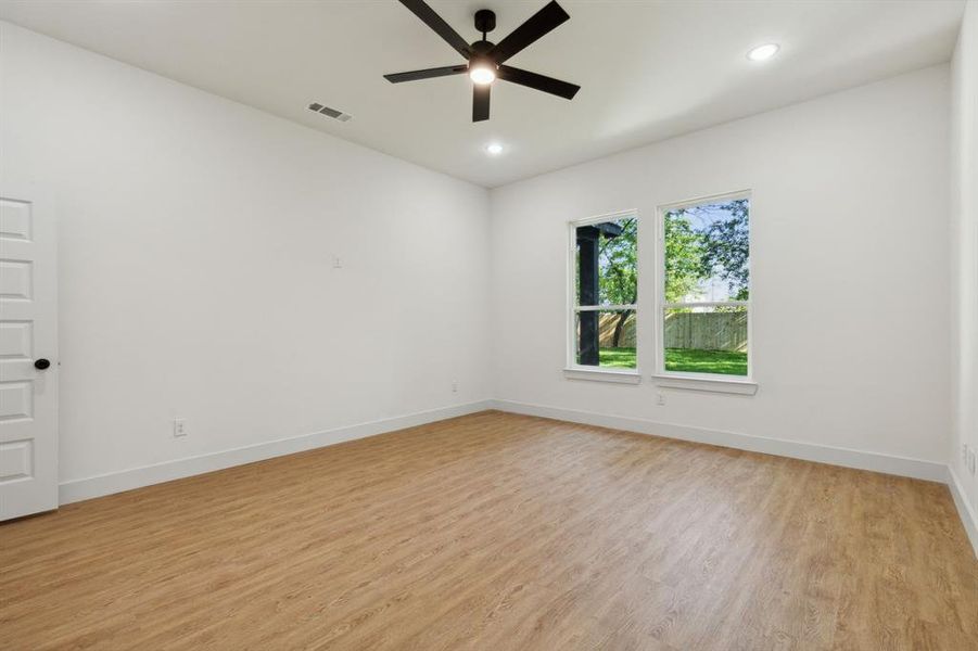 Unfurnished room featuring ceiling fan and light wood-type flooring