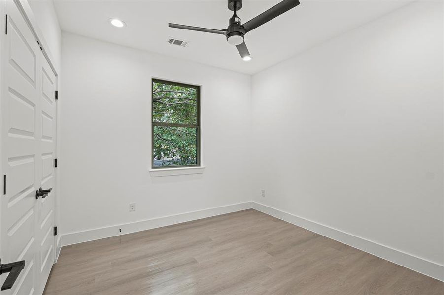 Unfurnished bedroom with light hardwood / wood-style flooring, ceiling fan, and a closet