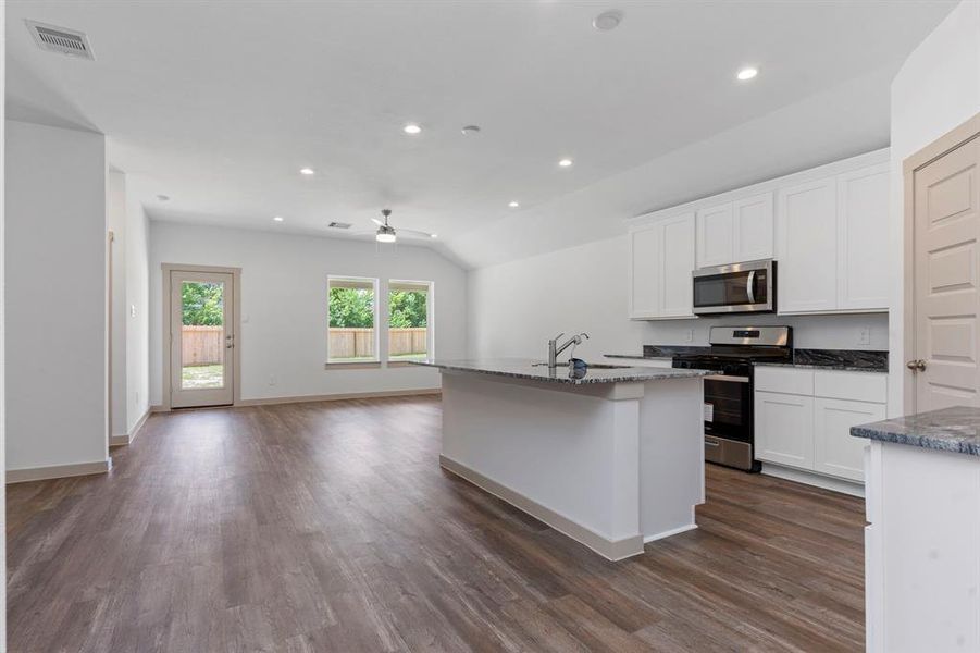 Those Gorgeous Wood Vinyl Plank Floors flow into the the Gourmet Kitchen! Fabulous Gourmet Kitchen with Tall Beautiful Shaker Cabinets! Stunning! **Image Representative of Plan Only and May Vary as Built**