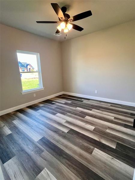 Unfurnished room featuring ceiling fan and hardwood / wood-style floors