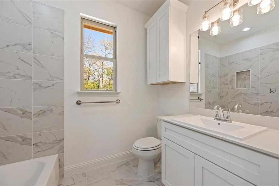 Full bathroom with vanity, plus walk in shower, and toilet