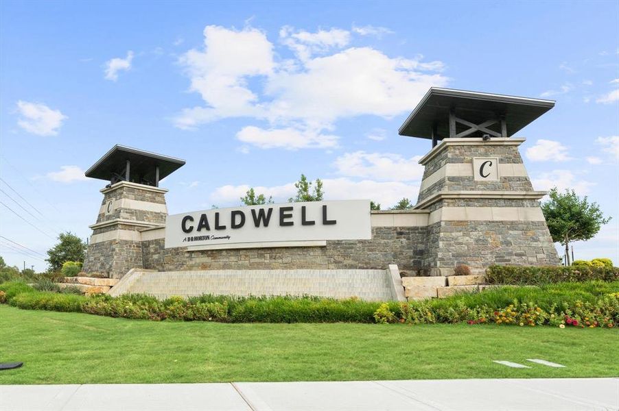 This image showcases the grand entrance to the "Caldwell Ranch" community, featuring prominent stone pillars with the community's name, highlighting its upscale and well-maintained atmosphere.