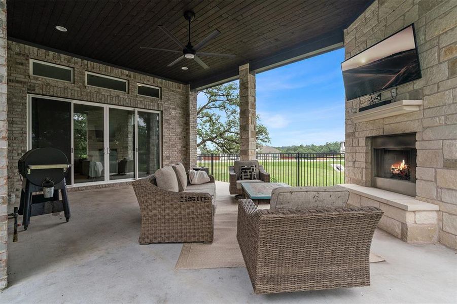 You;ll love the large covered patio with a stone fireplace and room for a future outdoor kitchen, all of which overlook the lush grassy yard and mature trees