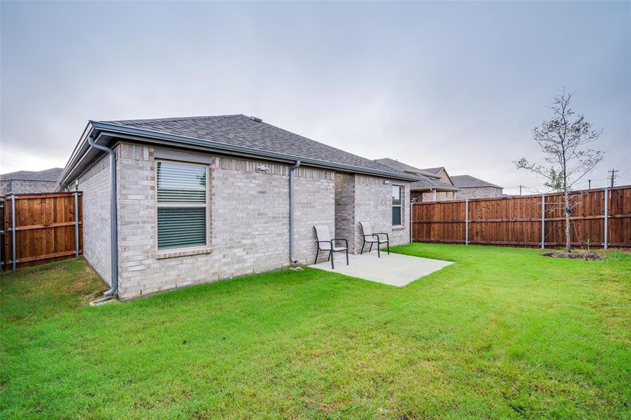 Back of property with a patio area and a yard