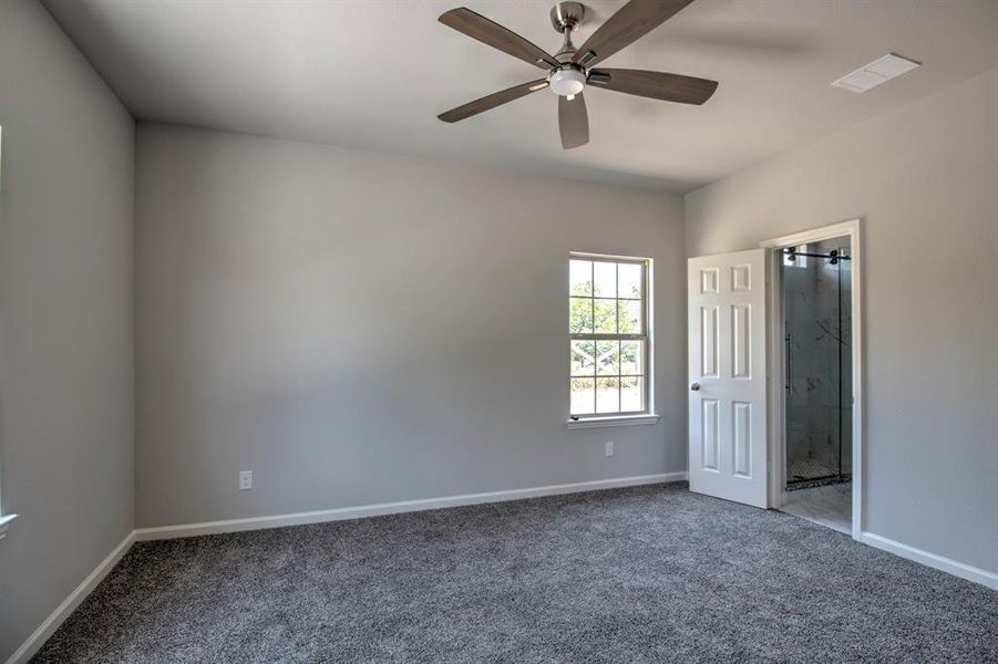 Unfurnished bedroom featuring carpet and ceiling fan