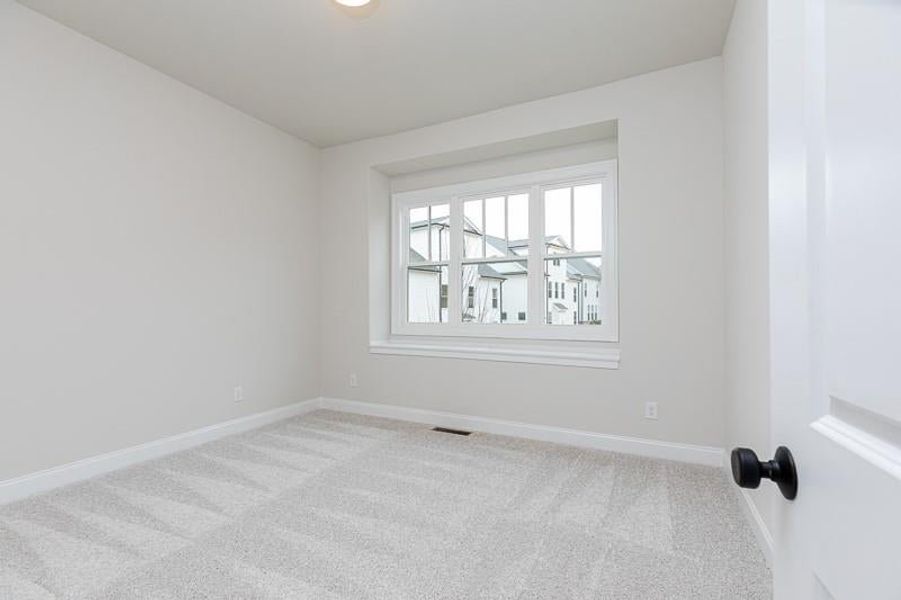 Spacious secondary bedroom and a large, walk-through second full bath with two separated vanities. Photo not actual home, but previously built Mansfield plan.