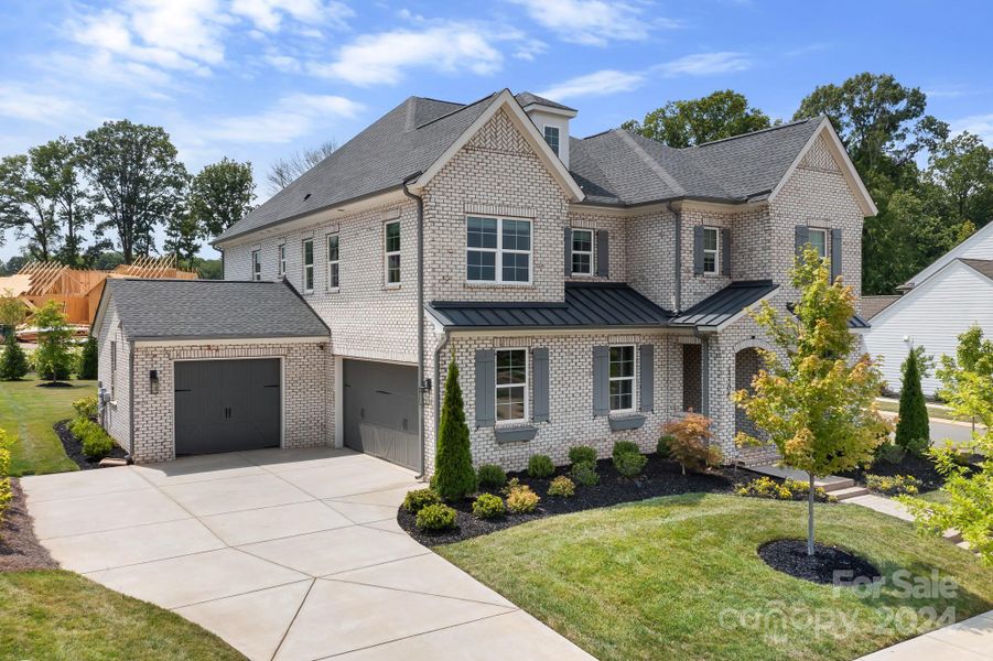 Home features a 2 car attached garage and a 1 car carriage garage.  Carriage garage can be access from the interior of the home.