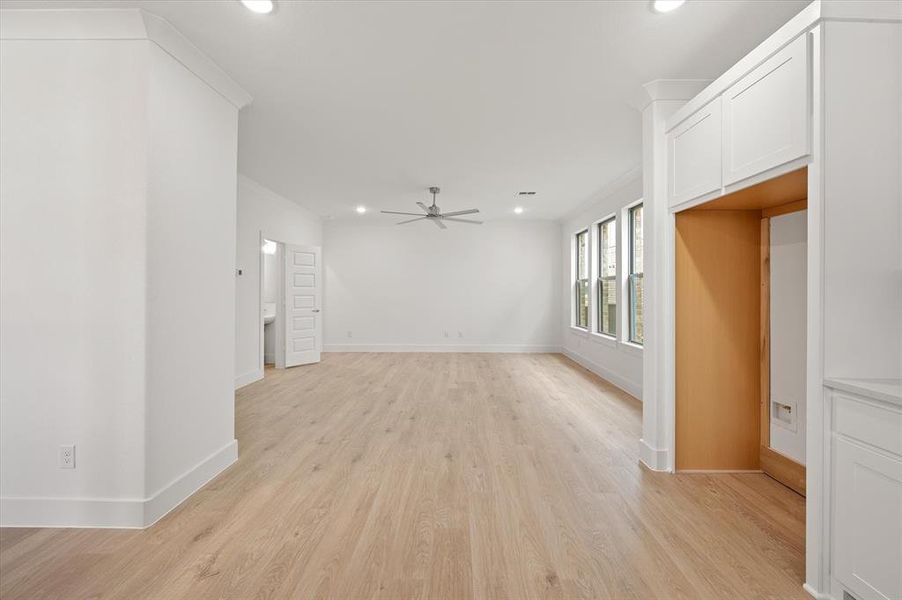 Unfurnished living room featuring light hardwood / wood-style floors and ceiling fan