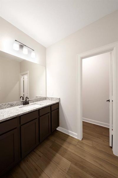 The master bathroom has a large sink with storage below and upgraded granite countertops that will stand the test of time. You will love getting ready for work or date nights in this bathroom.