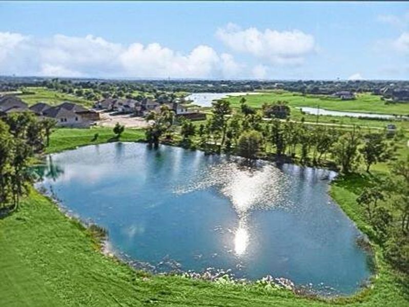 Birds eye view of property with a water view