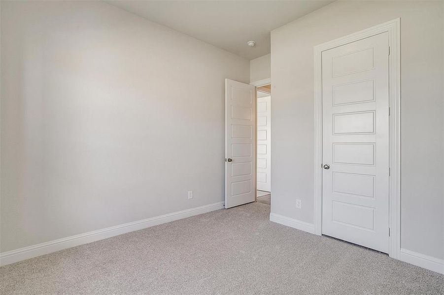 Unfurnished bedroom featuring light carpet