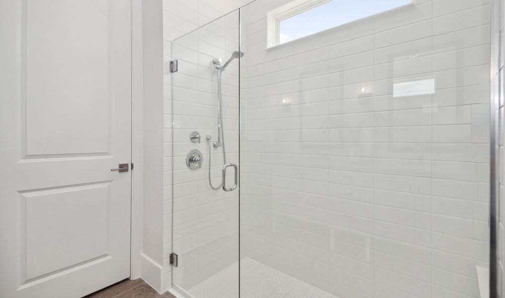 Lavish frameless shower door in primary