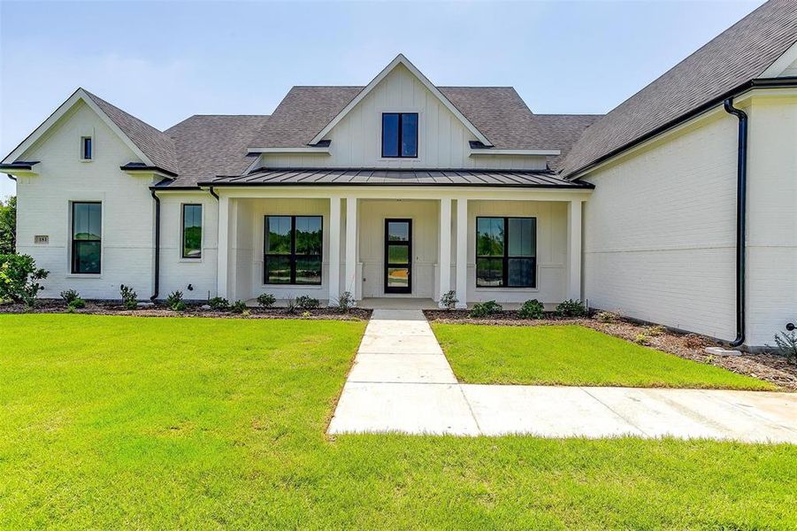 Modern farmhouse style home featuring a front yard