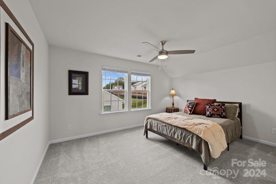 Upstairs bedroom with beautiful natural light streaming. Walk in closet.