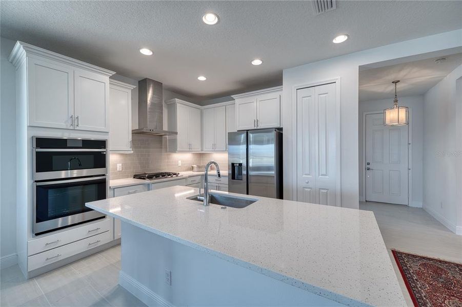 Kitchen: Notice the large quartz island; perfect for entertaining.