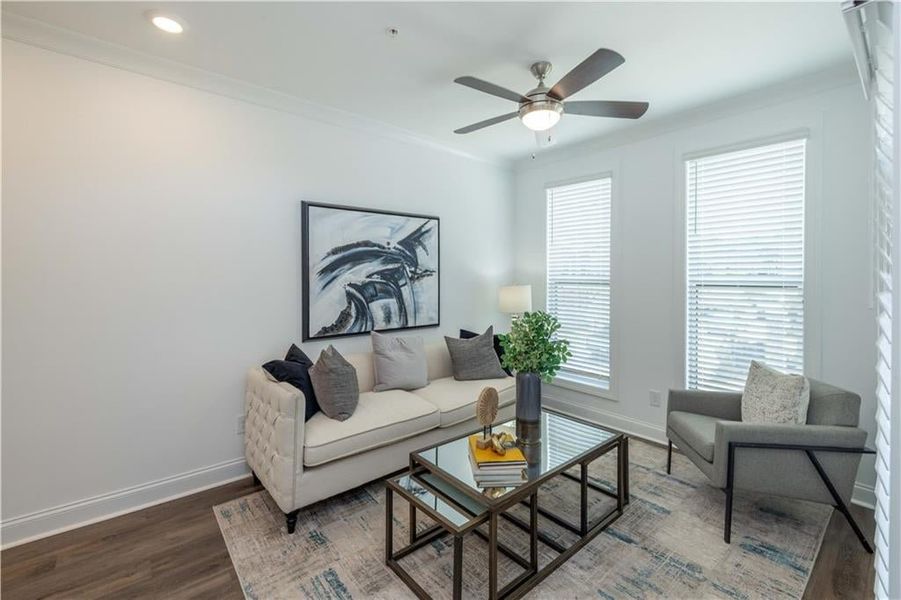 Sunroom  with wood-type flooring, ornamental molding, and ceiling fan, located behind Kitchen wall , not the actual unit