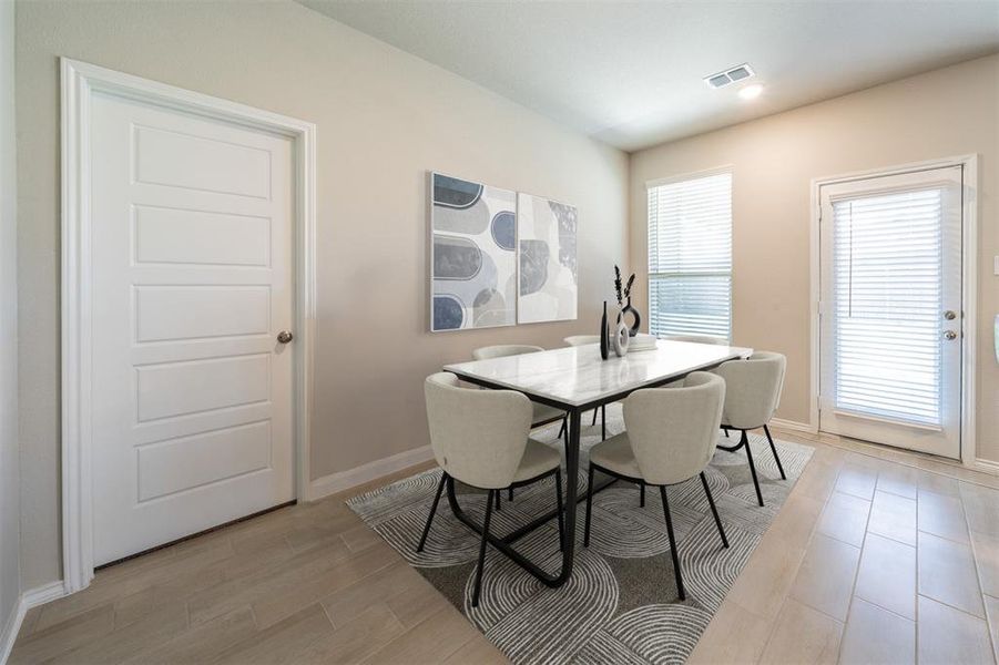 Dining room featuring a wealth of natural light and light hardwood / wood-style flooring