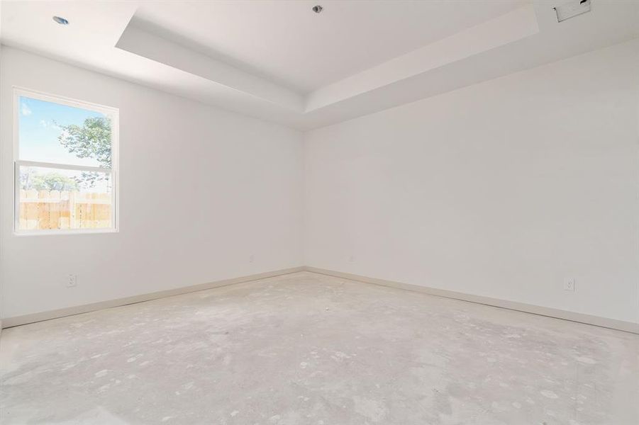 Empty room featuring a tray ceiling