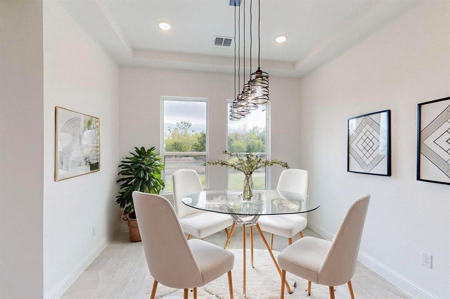 Dining space featuring a tray ceiling