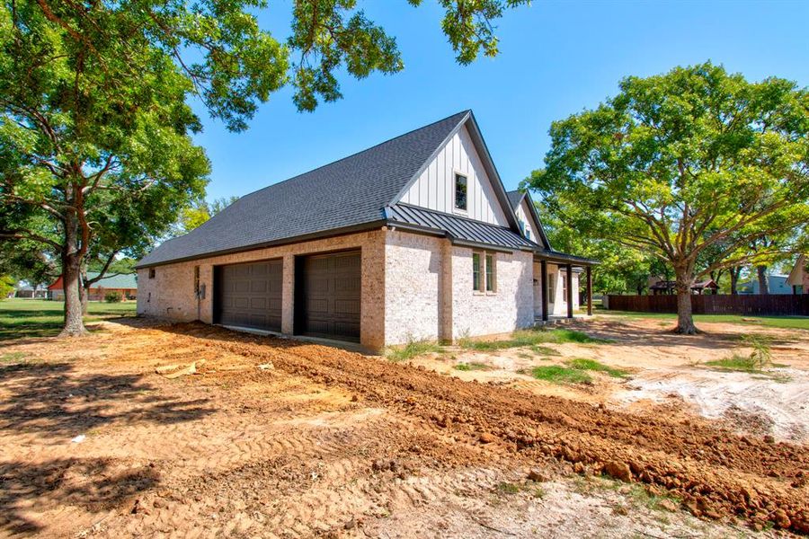 View of side of home featuring a garage