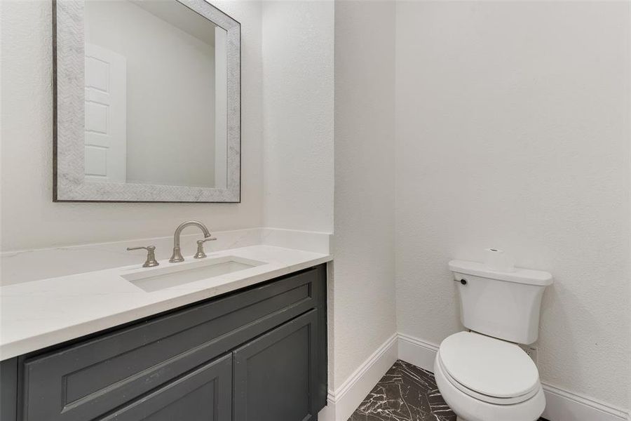 Bathroom featuring vanity and toilet