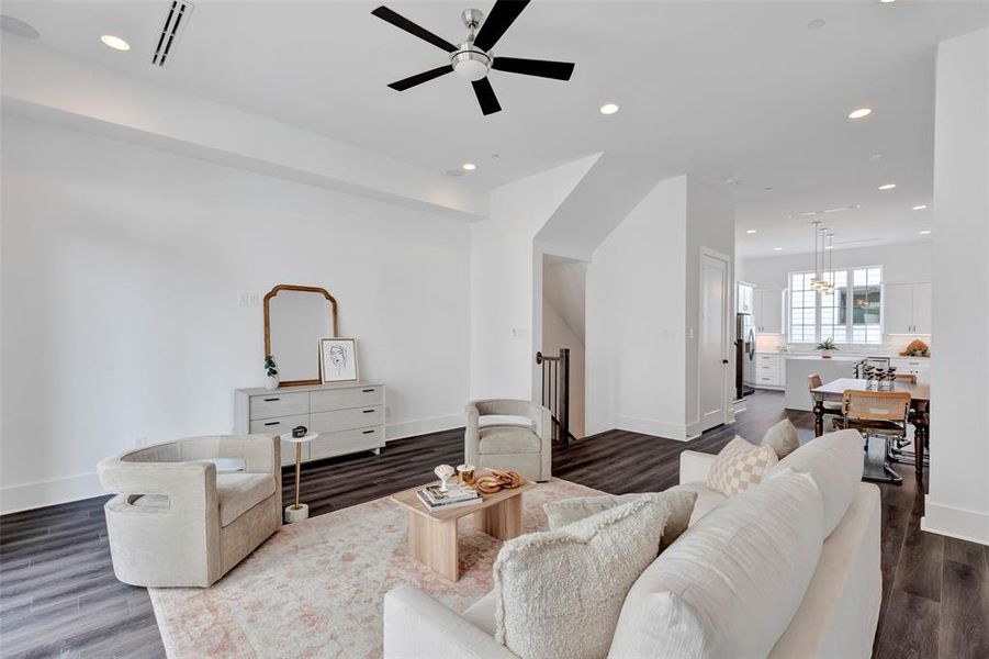 The living room seamlessly flows into the dining area and kitchen, creating an open and airy space great for entertaining family and friends.