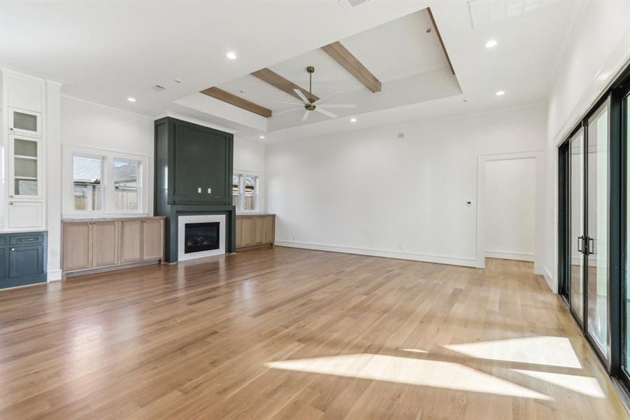 White oak cabinets and ceiling beams provide warmth to the space.