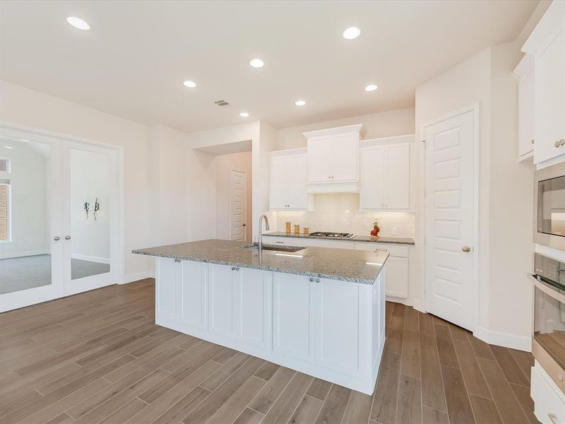 Another view of the beautiful kitchen.  To the left is the flex room which could be used as a TV/Media room, dedicated office or formal dining.