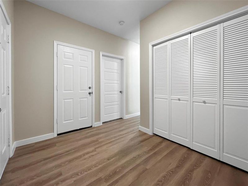 Entry way with dark hardwood /wood-style flooring