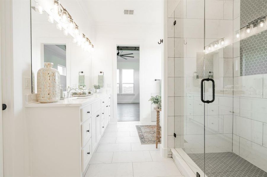 Bathroom with an enclosed shower, tile patterned floors, ornamental molding, ceiling fan, and vanity