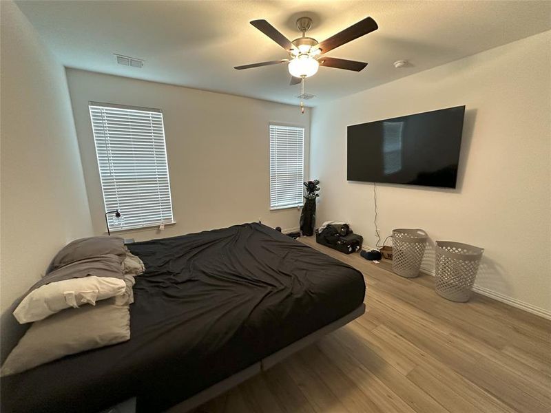 Bedroom with ceiling fan and light hardwood / wood-style floors