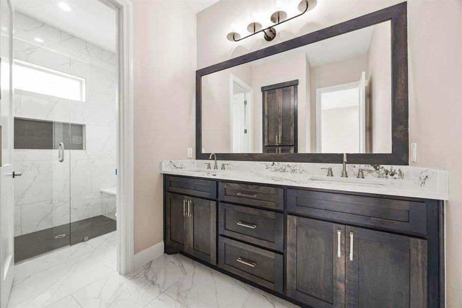 Bathroom featuring walk in shower, tile patterned floors, and dual bowl vanity