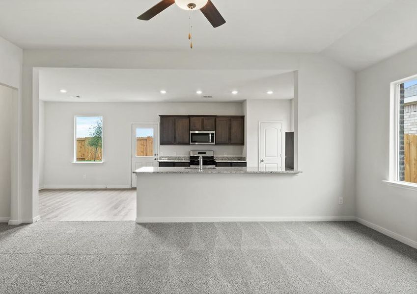 The open layout connects the family room with the kitchen and dining room.