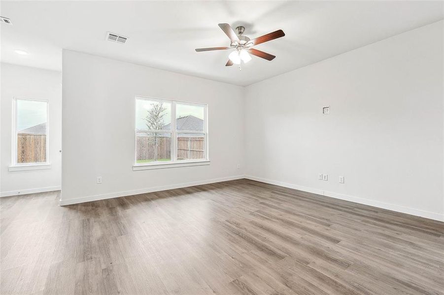 Unfurnished room with ceiling fan and wood-type flooring