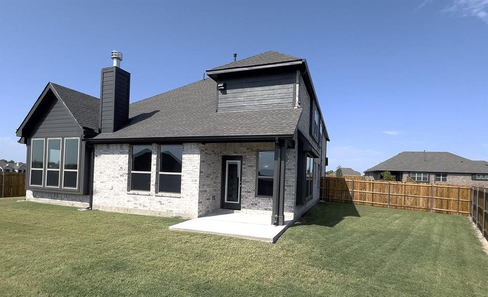 Back of house featuring a yard and a patio area