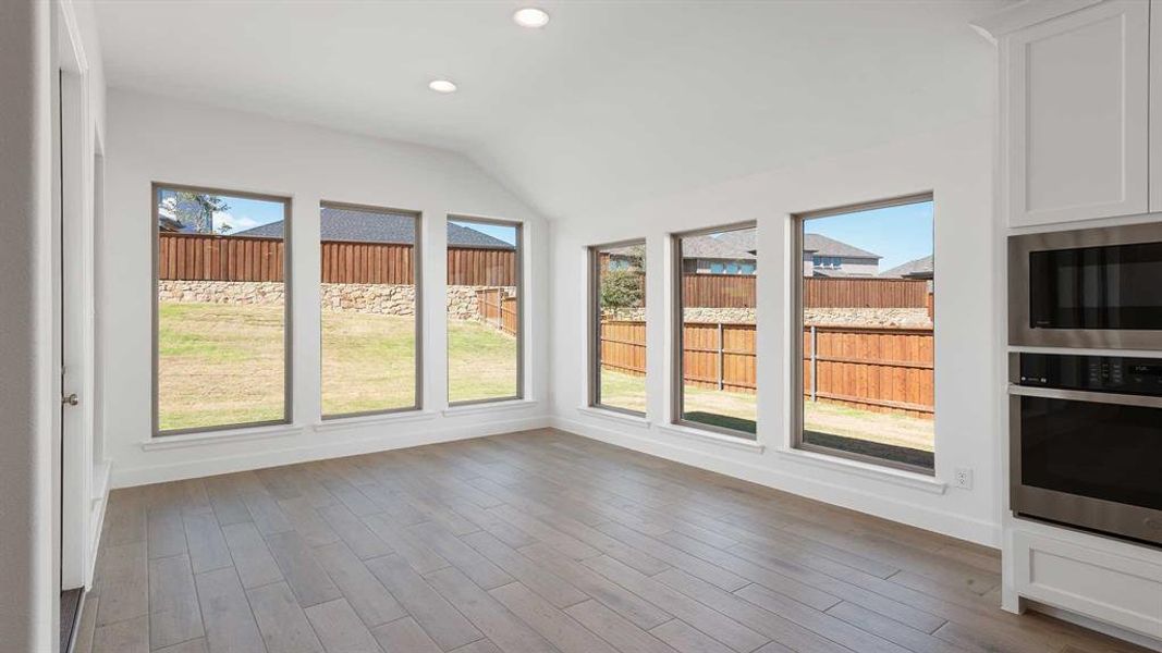 Unfurnished sunroom with vaulted ceiling