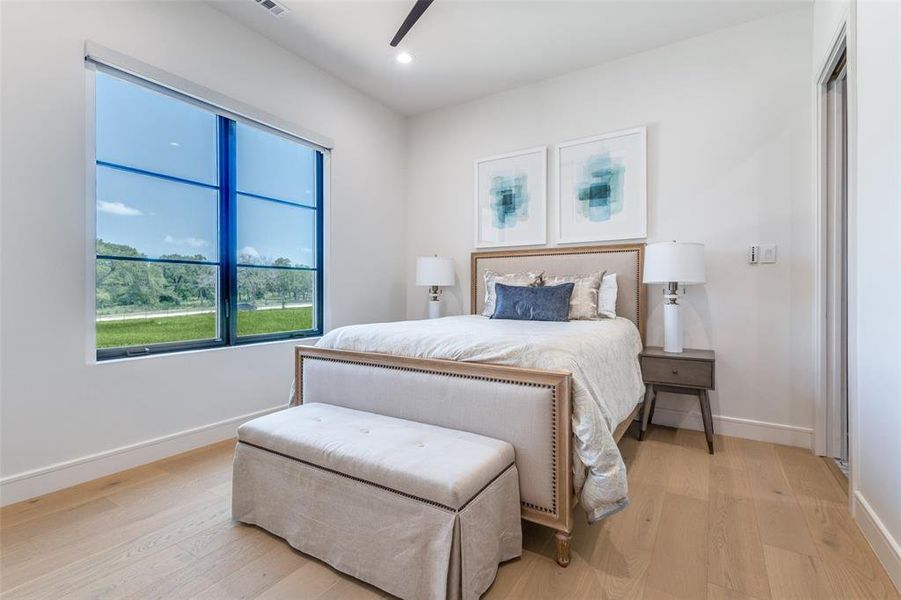 Bedroom with light hardwood / wood-style flooring