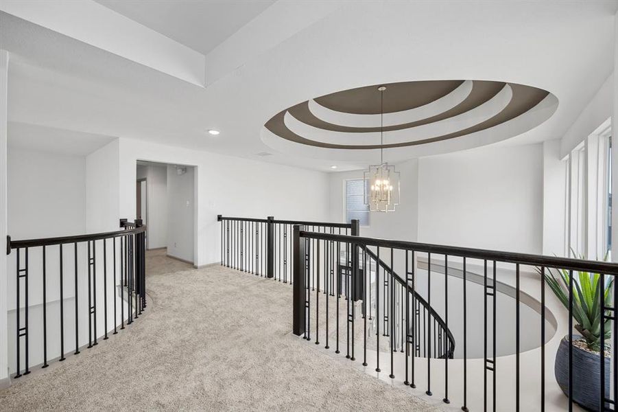 Stunning view of the spiral staircase and rotunda design leading downstairs.