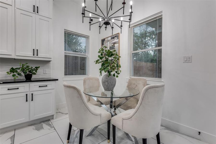 Breakfast nook area with modern candelabra lighting fixture.