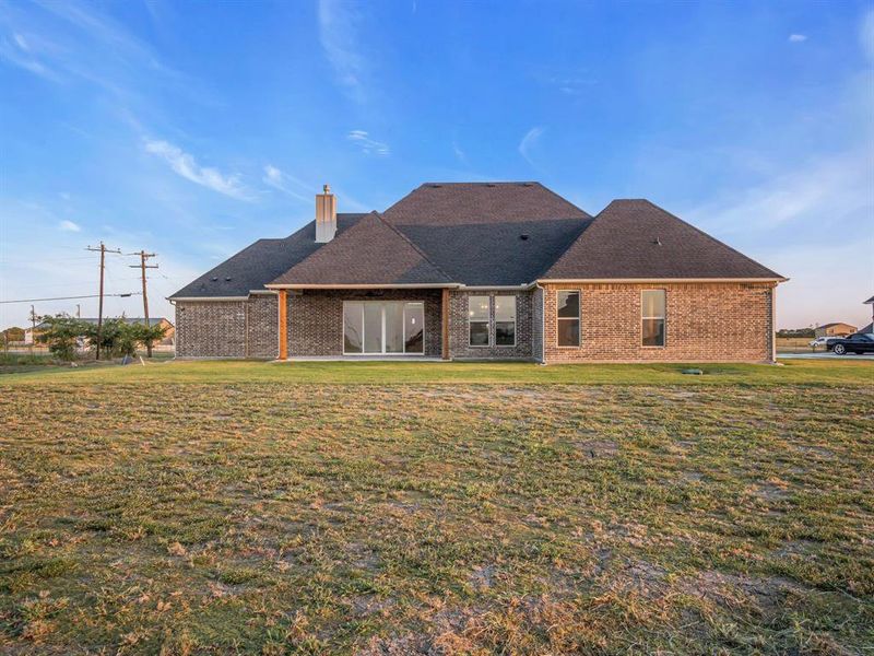 Back of property with a patio and a yard